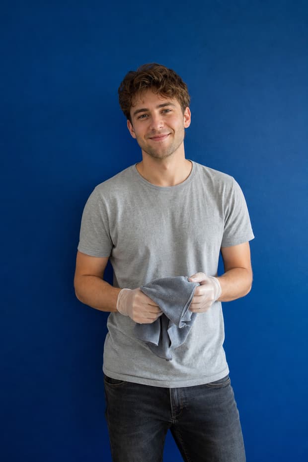 A new cleaner holding a microfibre cloth